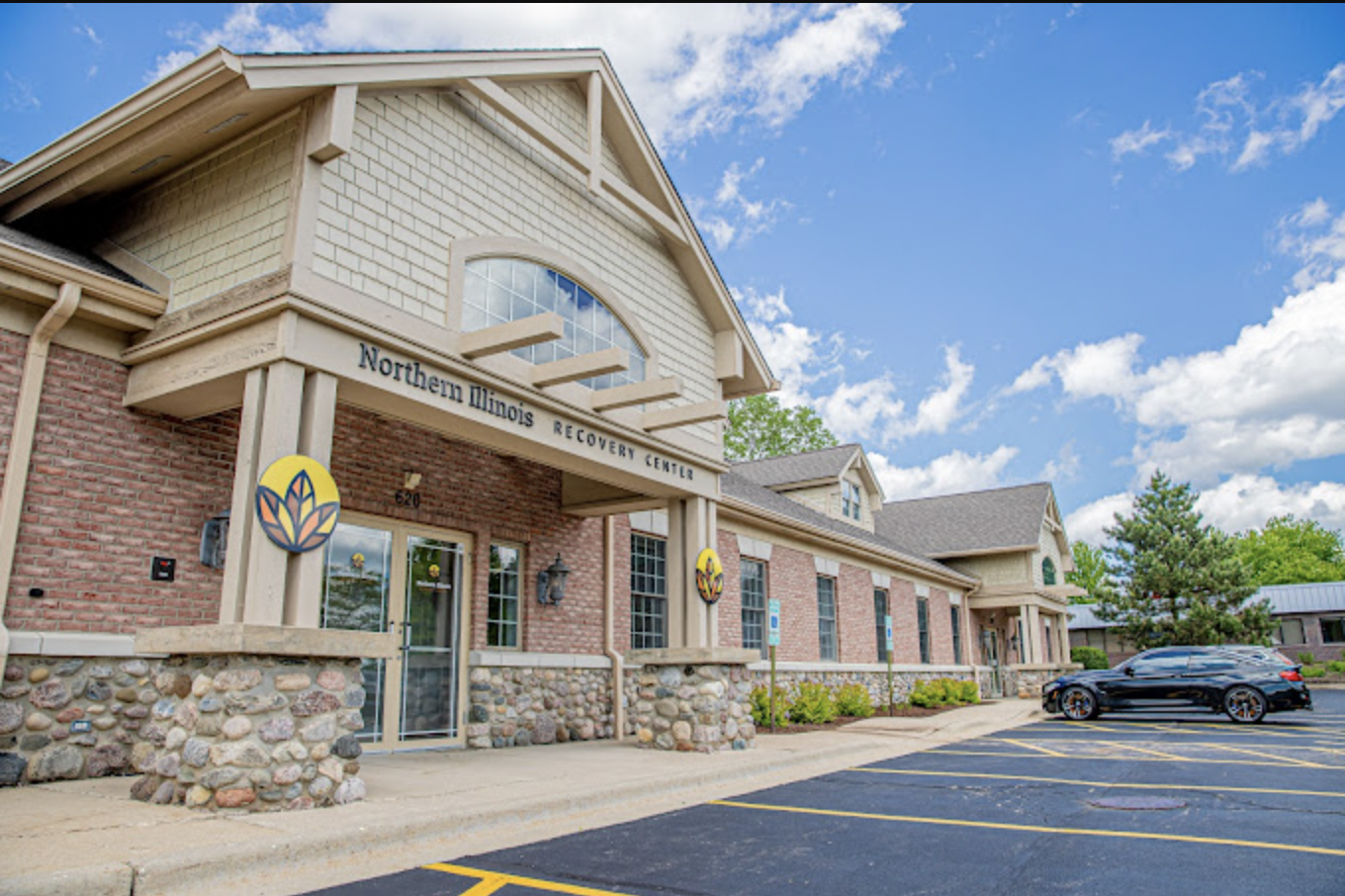 Exterior view of Northern Illinois Recovery Center brick building with main entrance, stone accents, and facility signage