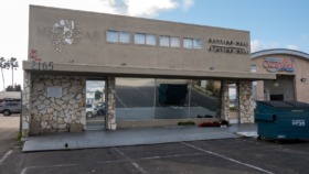 Exterior view of Miramar Recovery Center building showing main entrance with stone base, address 2165, facility signage, and parking area