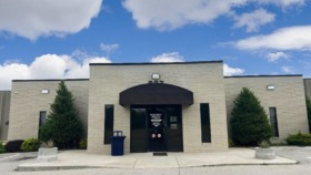 Exterior view of Ponca City Rightway Medical facility showing brick building with black awning entrance, landscaping, and parking area