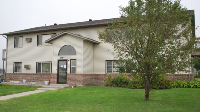 Exterior view of Gull Harbour treatment center showing main entrance at 1704 Belsly Blvd with brick and siding, landscaped grounds, and lawn