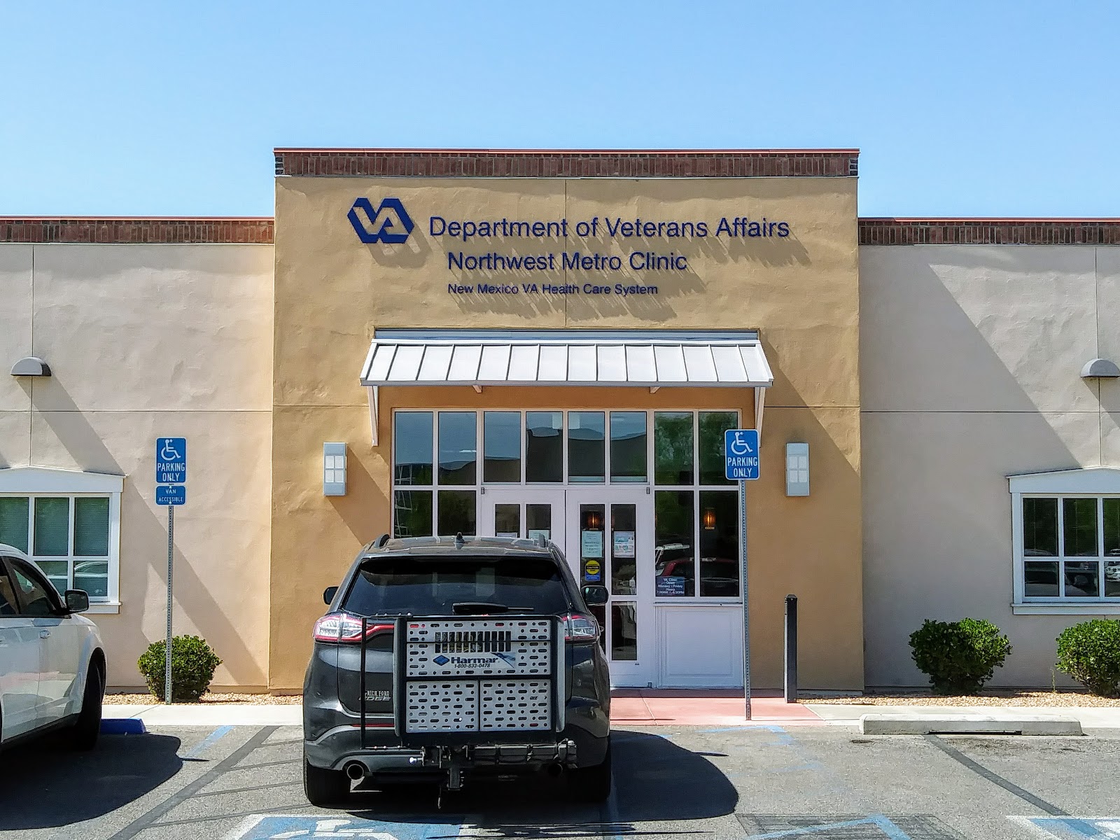 Exterior view of Department of Veterans Affairs Northwest Metro Clinic building with main entrance, accessible parking, and facility signage