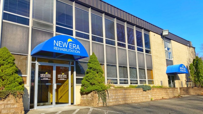 Exterior front entrance of New Era Rehabilitation Center showing blue awning, glass doors, address 4675, and landscaping