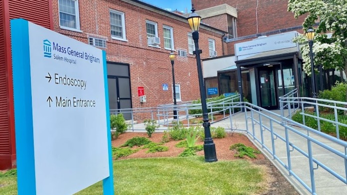 Exterior main entrance showing brick construction, walkway, and healthcare facility entrance signage