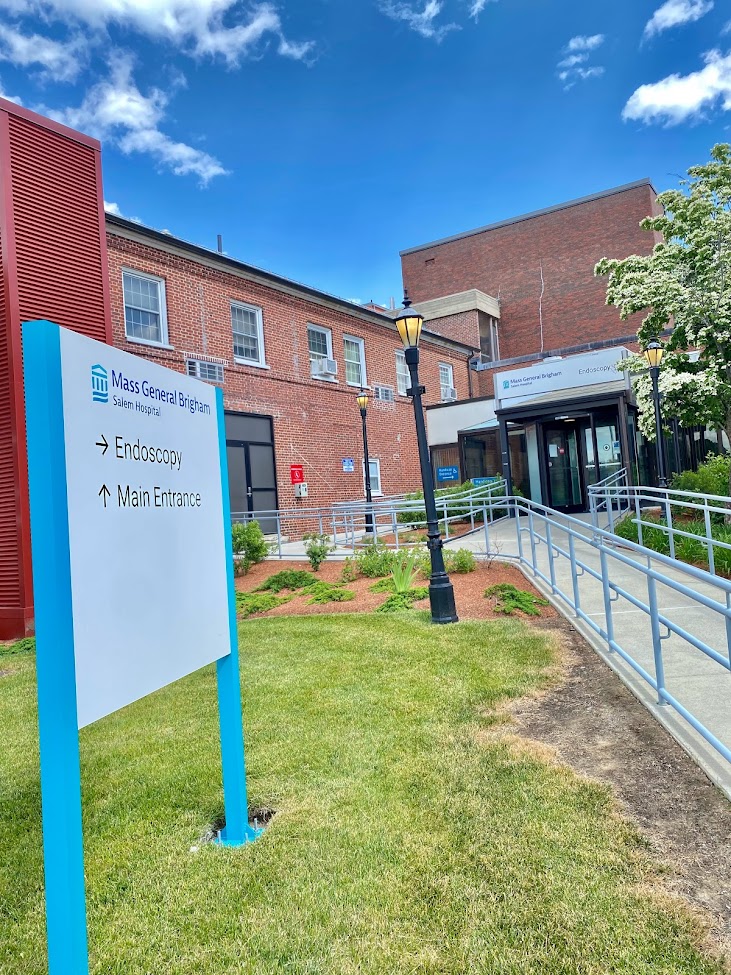Exterior main entrance showing brick construction, walkway, and healthcare facility entrance signage