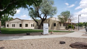 Exterior view of Southeast Mental Health Services main building with cream-colored facade, large mature tree, manicured lawn, and facility signage