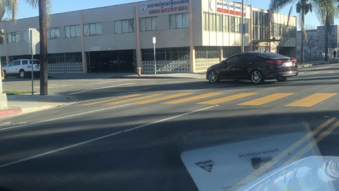 Exterior view of Cambodian Association of America building on Pacific Avenue with organization signage and parking area
