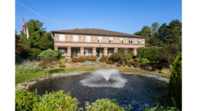 Exterior of two-story brick treatment facility with landscaped grounds, water fountain, and professional grounds