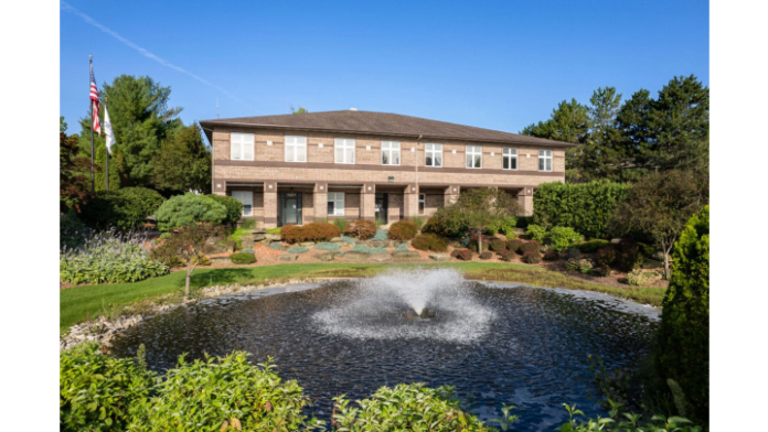 Exterior of two-story brick treatment facility with landscaped grounds, water fountain, and professional grounds