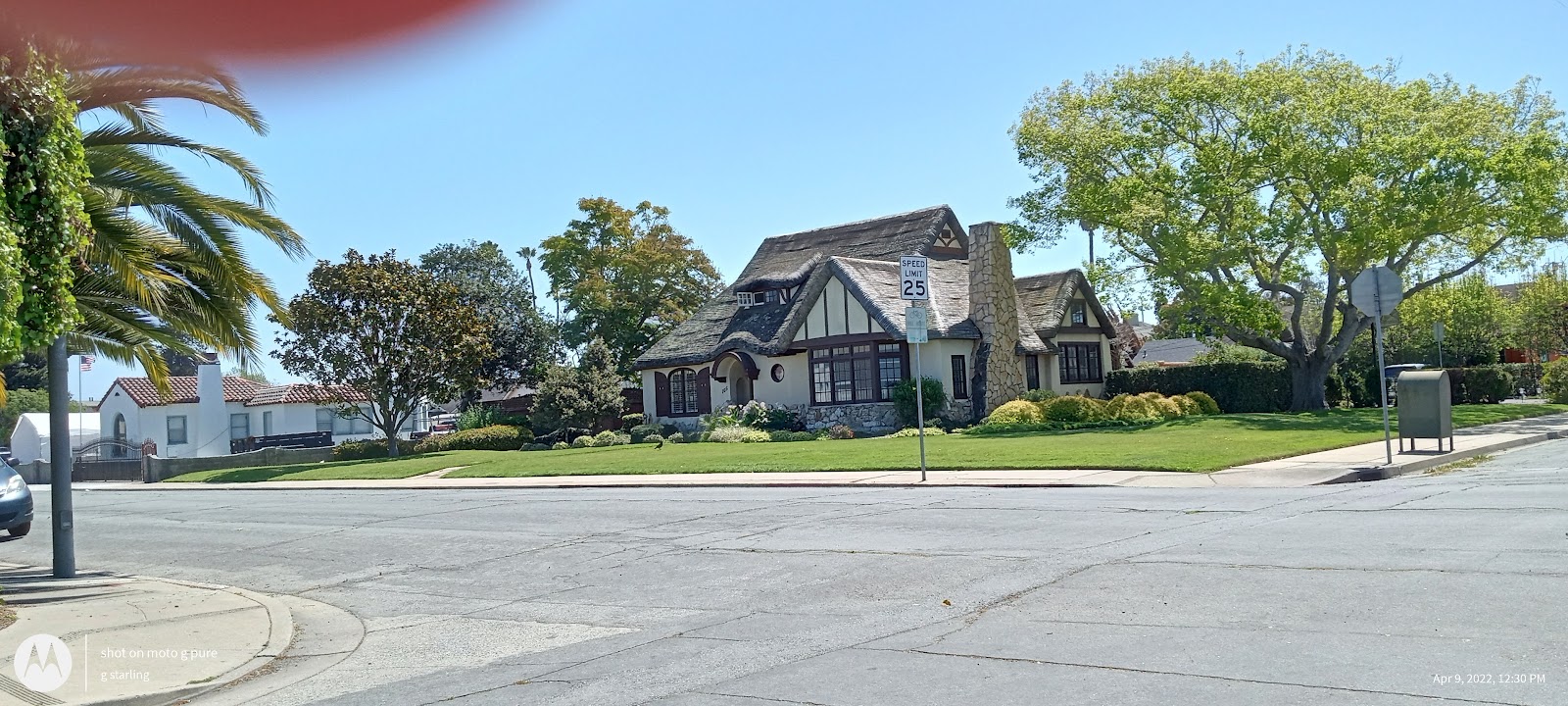 Exterior view of Tudor-style treatment facility with landscaped front lawn, street signage, and parking area