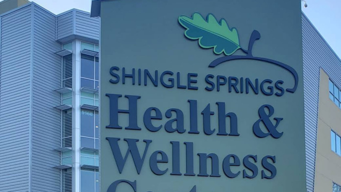 Exterior signage reading Shingle Springs Health and Wellness Center with oak leaf logo on building facade