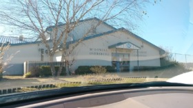 Exterior view of McDowell Center for Children facility in Dyersburg, Tennessee showing main entrance with blue accents and signage