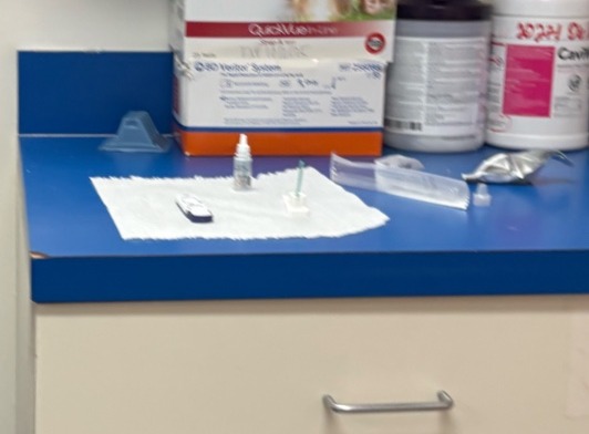 Interior utility counter with QuickCheck test boxes, hand sanitizer bottles, sterile gauze, and medical supply organization