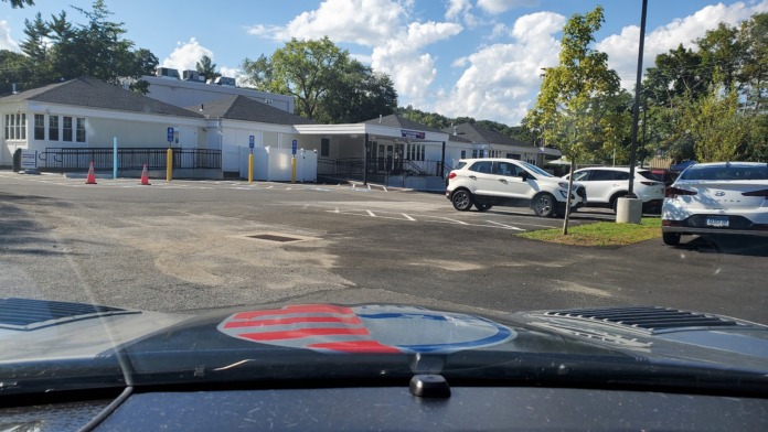 Exterior showing Ansonia Methadone Clinic entrance with security gate, facility signage, and secure entry area