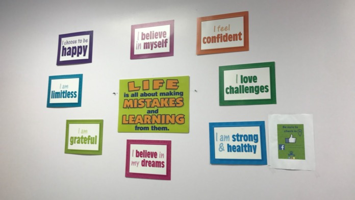 Interior wall showing framed positive affirmation messages displayed as inspirational resources for facility visitors.