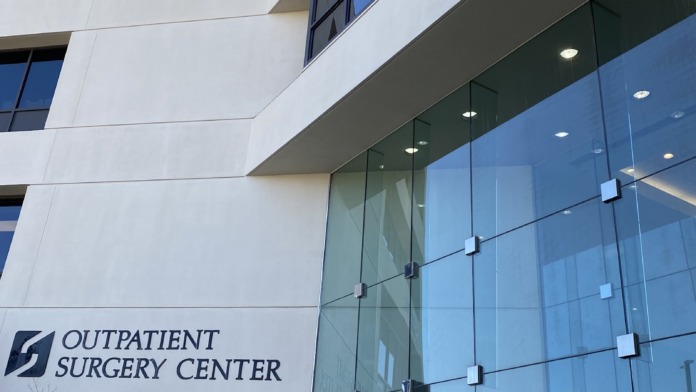 Exterior of outpatient surgery center building with address 1250, glass storefront entrance, and landscaping