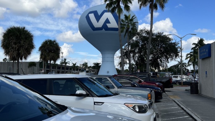 Exterior parking lot view showing VA medical center water tower and facility signage
