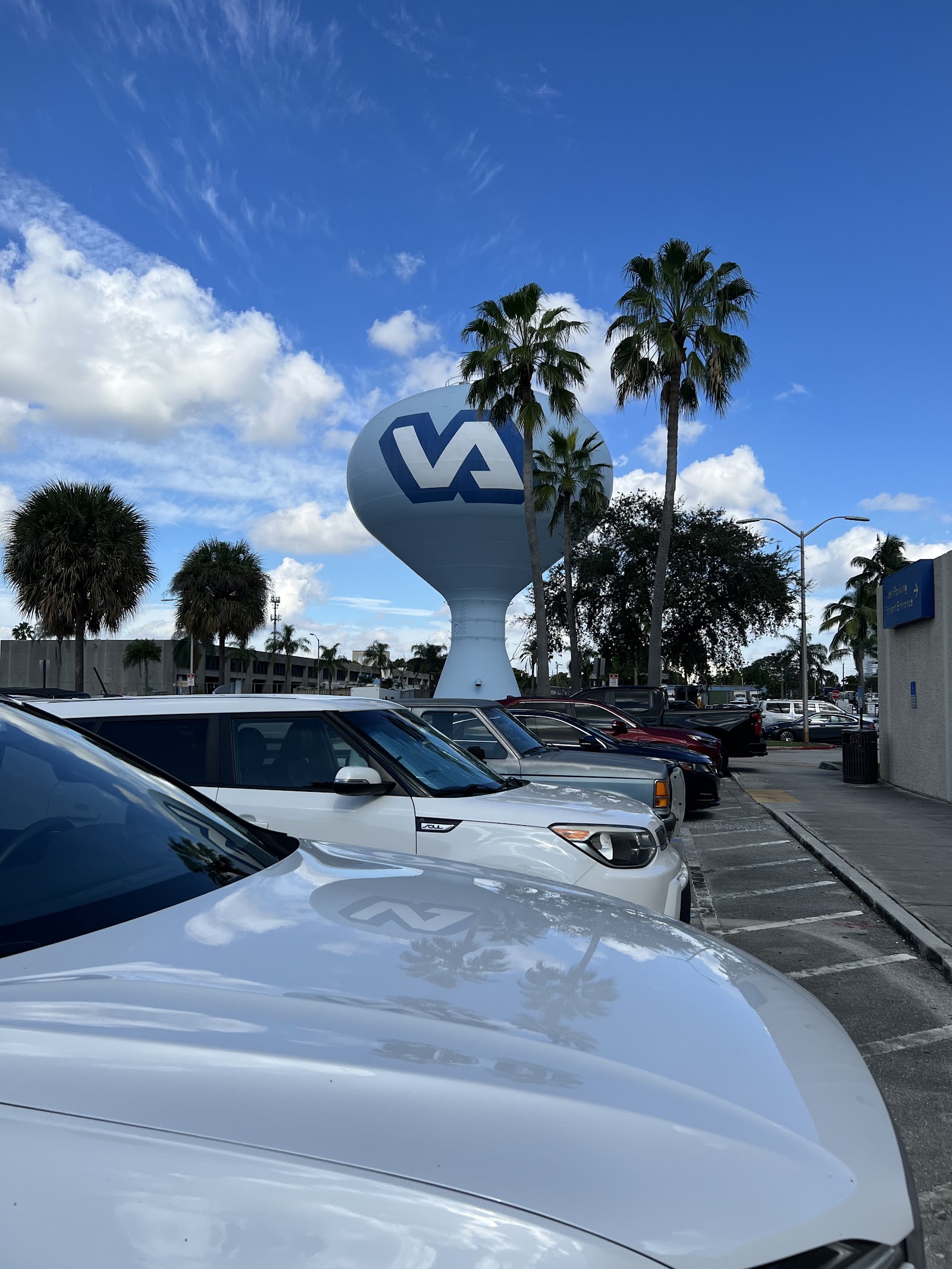 Exterior parking lot view showing VA medical center water tower and facility signage