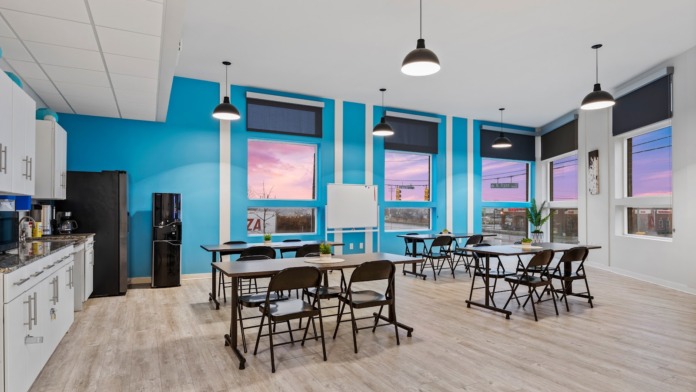 Interior office with large windows, natural light, desk with computer setup, and scenic outside views