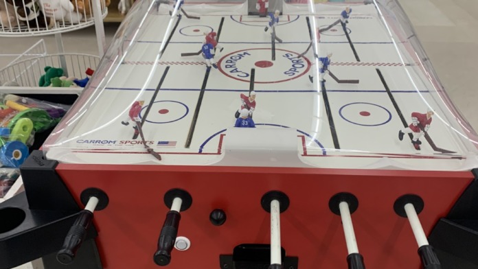 Interior recreation area featuring foosball table, bookshelves, toys, and game equipment for resident activities
