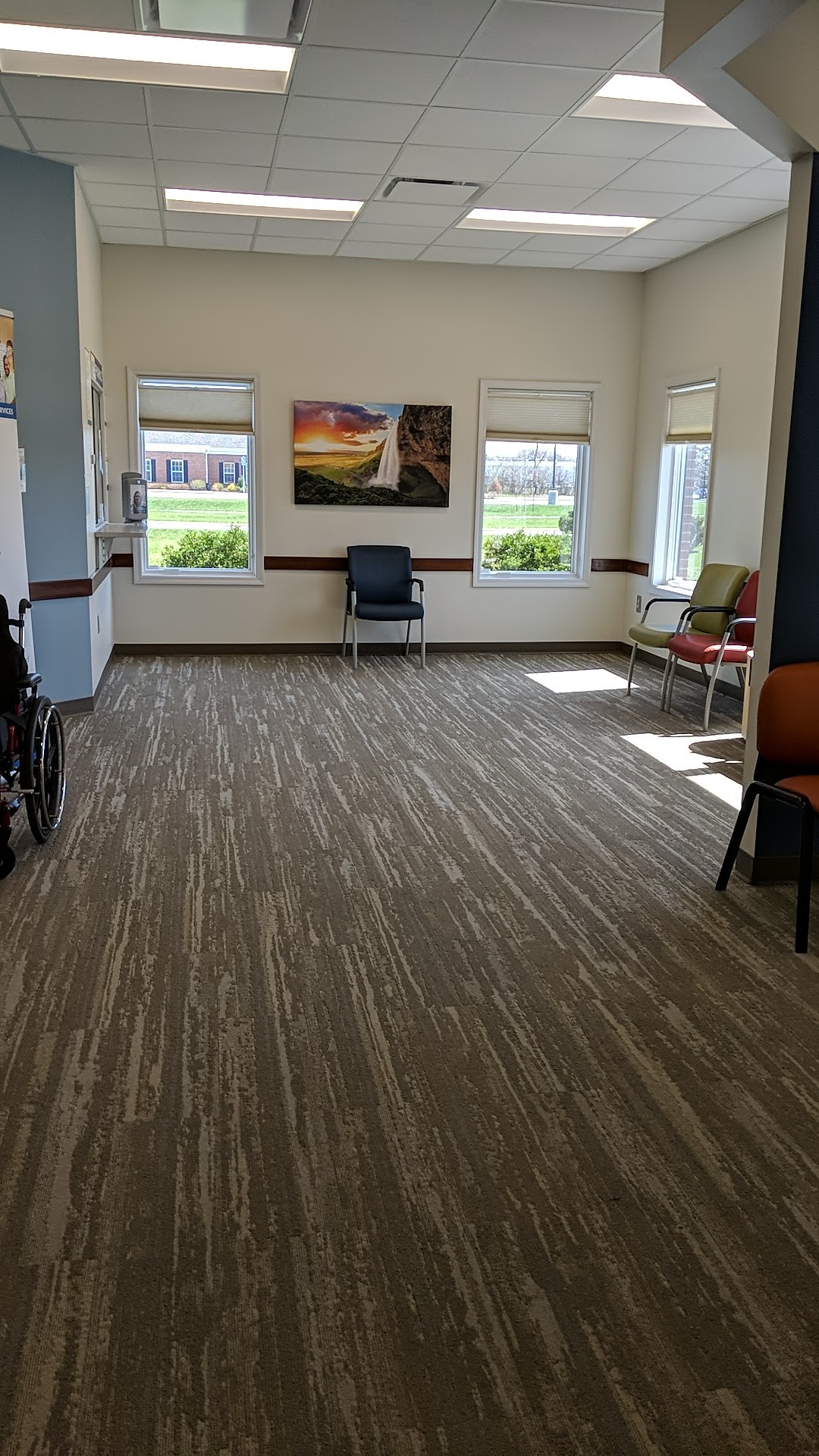 Interior recreational space with multiple windows, seating, wall art, and natural outdoor views