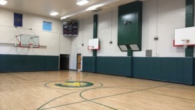 Interior common area with seating, dining table, and game equipment for recreational activities