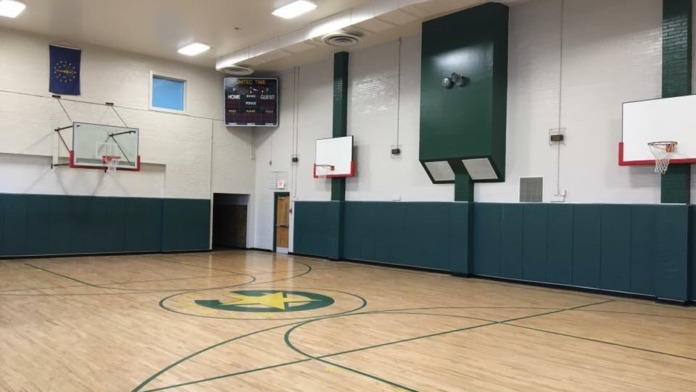 Interior common area with seating, dining table, and game equipment for recreational activities