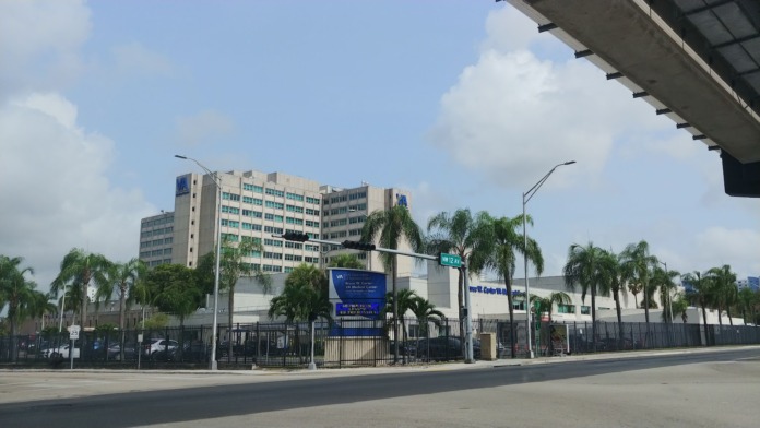 Exterior view showing side entrance with Bruce W. Carter VA Medical Center signage and landscaping