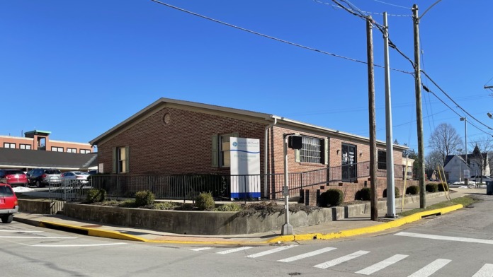 Exterior single-story brick medical facility with low entrance and marked parking lot