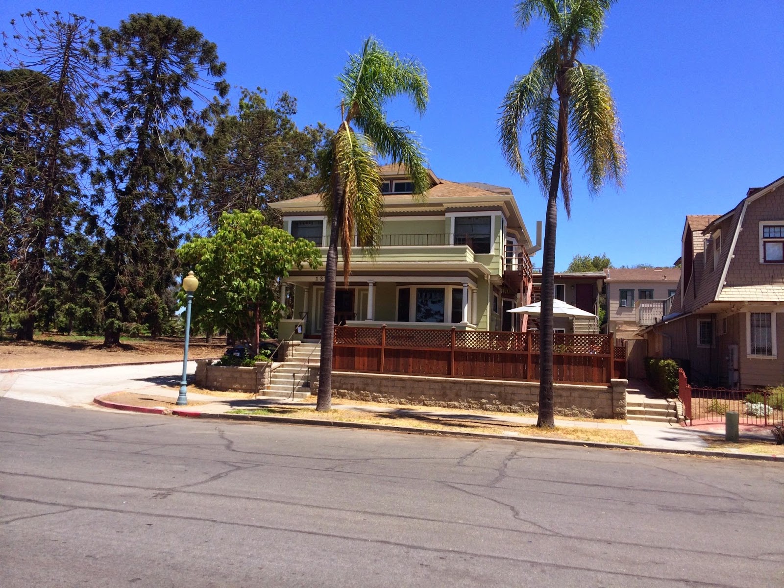 Exterior street view of treatment facility showing full two-story building facade with palm trees and neighboring residential properties