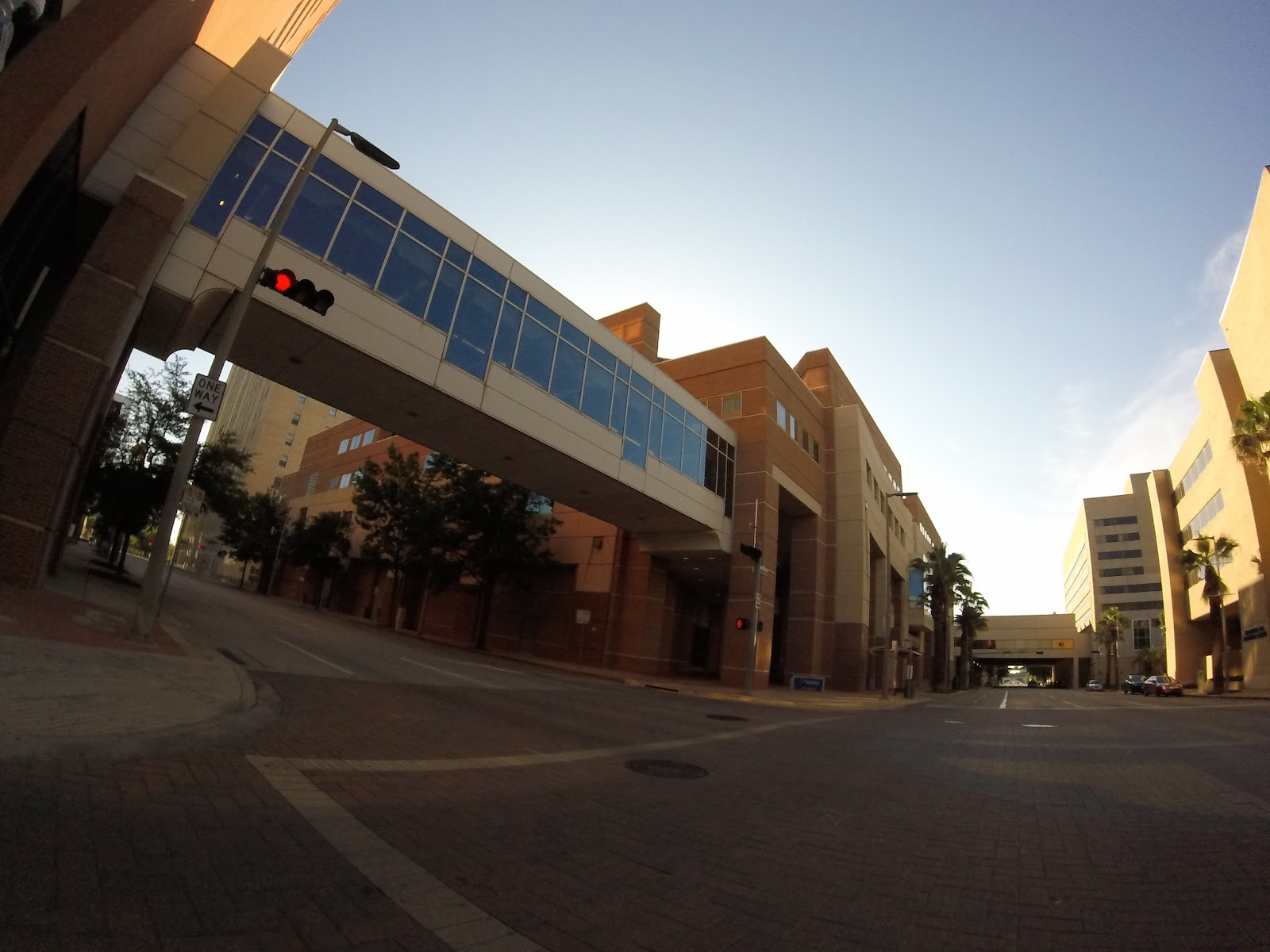 Exterior street view of hospital complex showing main building structure, parking areas, and traffic control signage