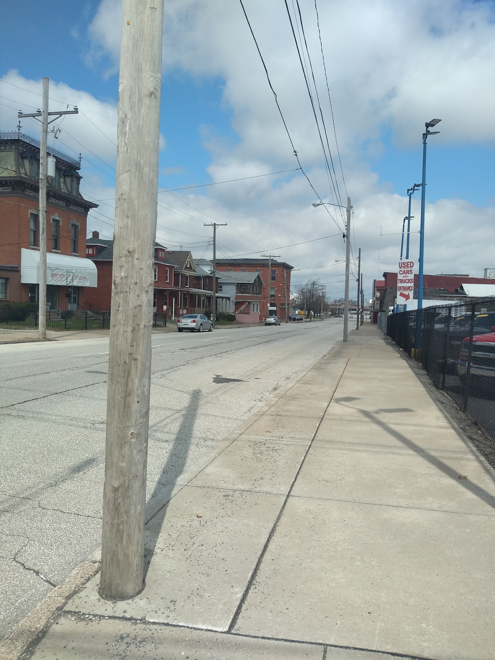 Exterior street view showing sidewalk, utility poles, and surrounding brick buildings in Erie neighborhood