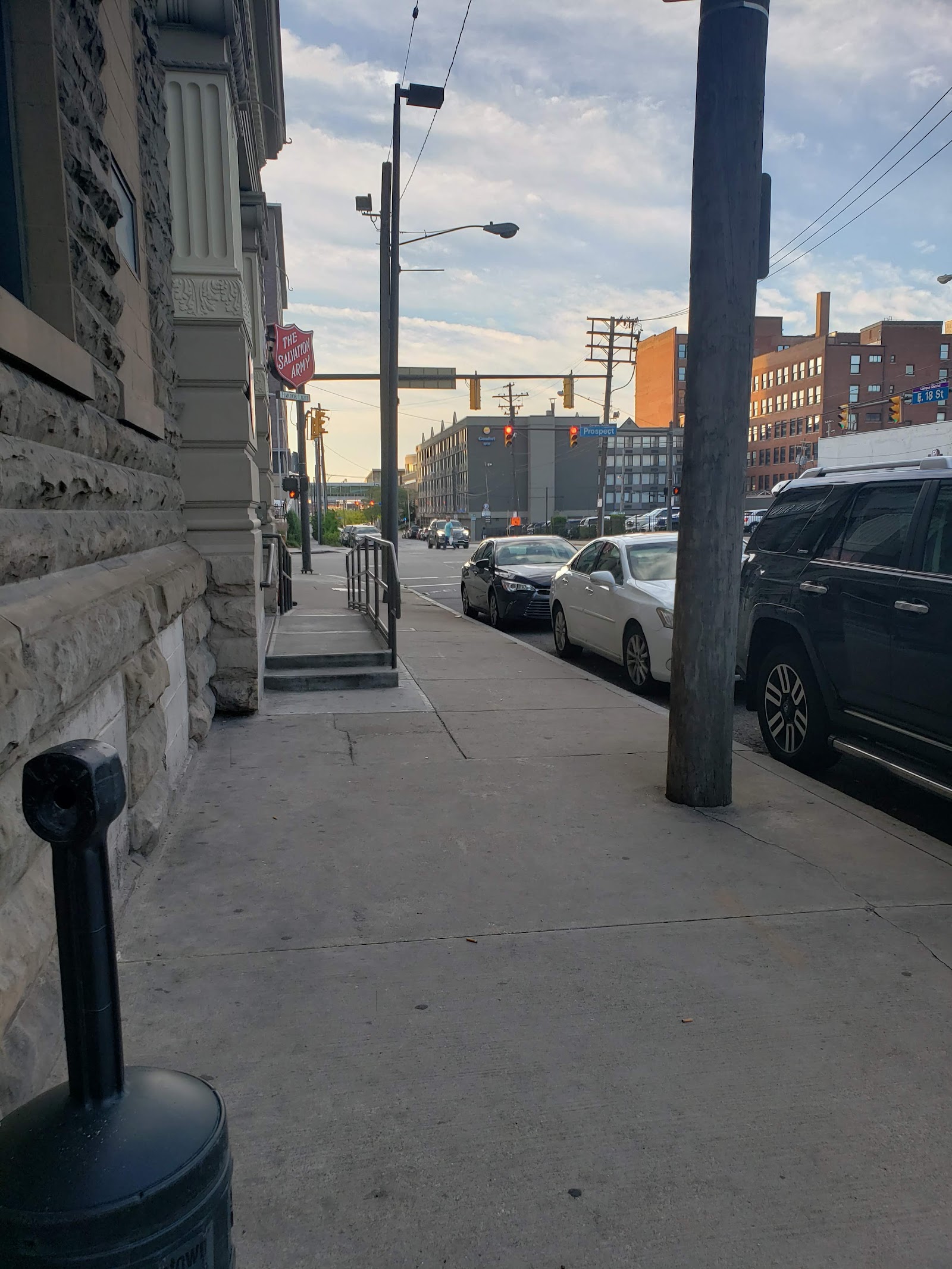 Exterior street view showing facility entrance area with sidewalk, building facade, and urban street