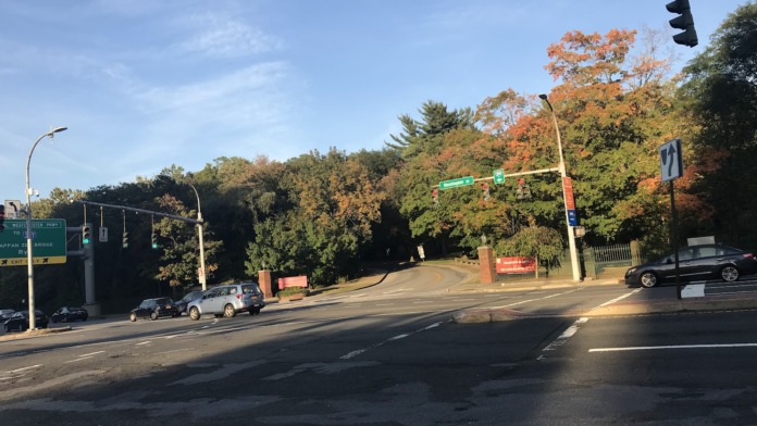 Exterior street-level view showing facility entrance access with traffic signals and seasonal foliage