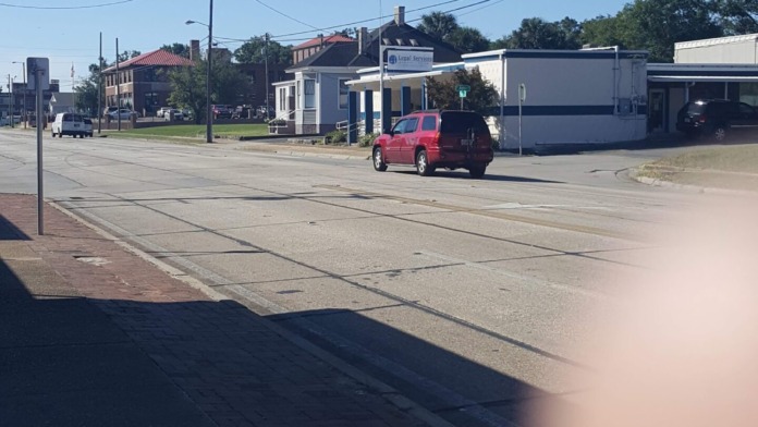 Exterior street view showing facility location with historic building architecture, utility vehicles, and surrounding commercial buildings