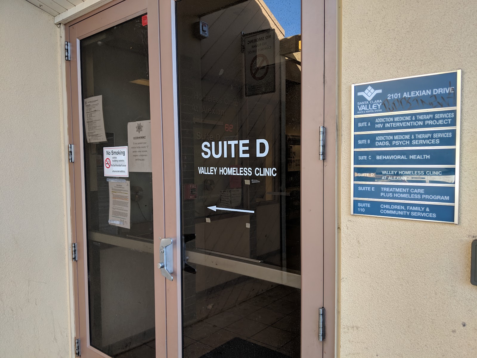 Entrance door and directional signage for Valley Homeless Clinic and Addiction Medicine Therapy Services.