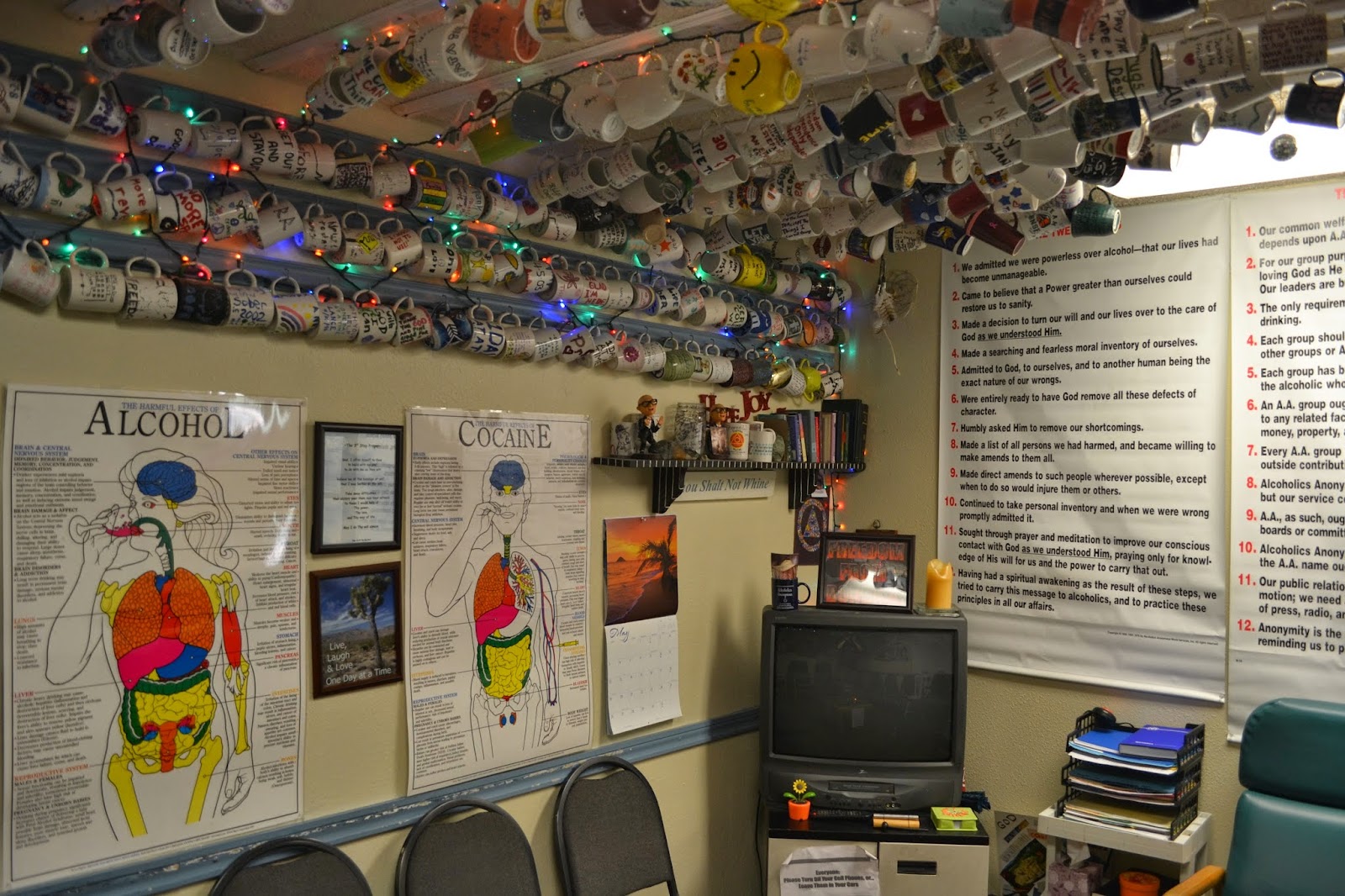 Interior wall display with educational charts about substances, recovery principles, and patient recovery artwork and decorations