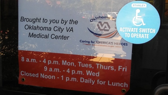Exterior signage for Department of Veterans Affairs Community-Based Outpatient Clinic in Ardmore, Oklahoma with operating hours and accessibility information