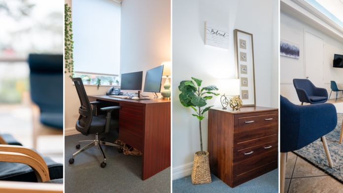 Interior office with desk, computer setup, decorative plants, and modern furnishings with window views