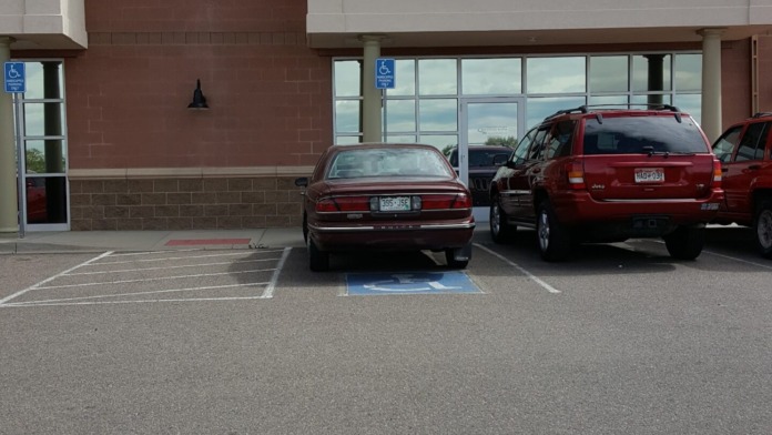 Exterior facility showing Mental Health Network signage, brick construction, glass windows, and parked vehicles