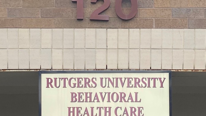 Exterior facade with address number 120 and Rutgers University Behavioral Health Care signage on brick wall