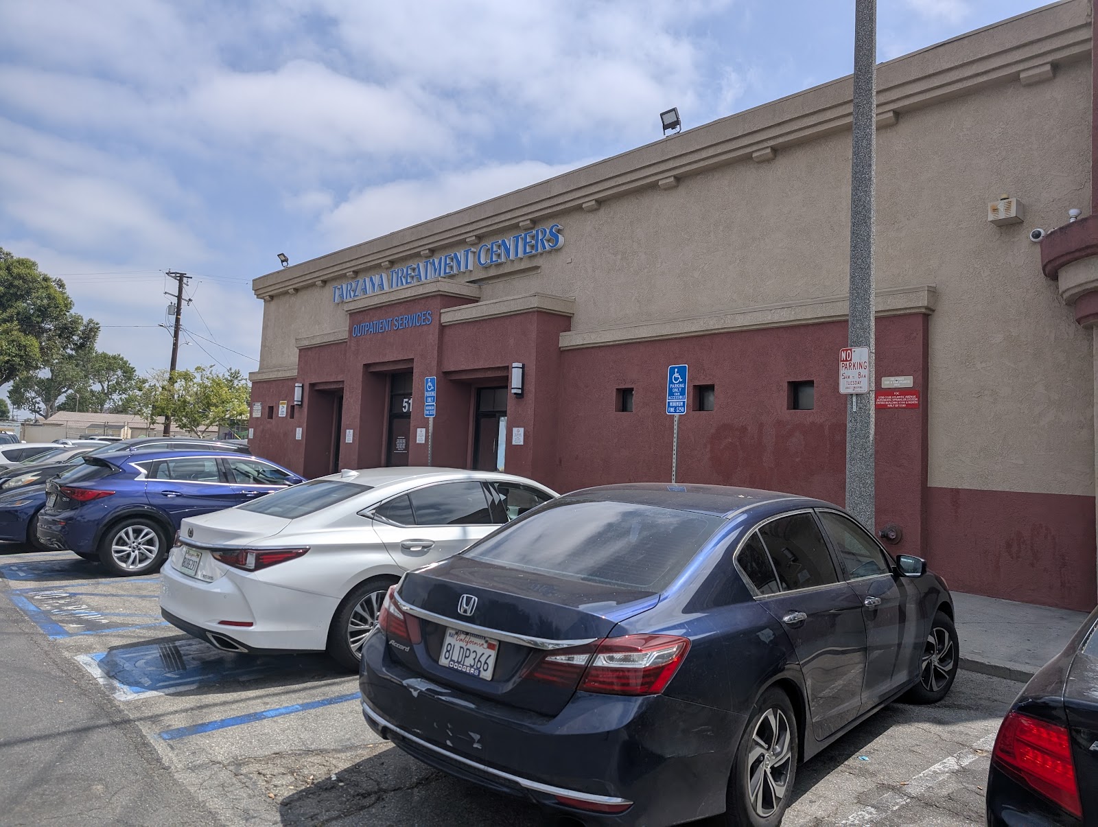 Exterior facade of treatment facility with maroon and tan colored walls and main entrance doors