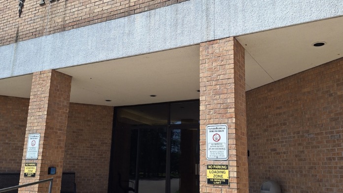Exterior South Arkansas Professional Plaza entrance with brick facade, covered entry, and street-facing storefront.