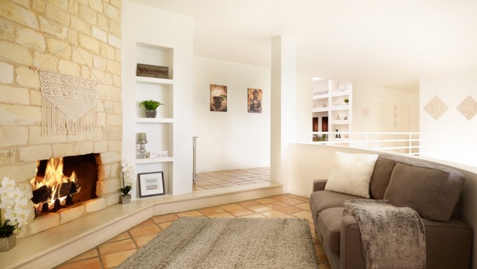 Interior common area with fireplace, comfortable seating, built-in shelving, and macrame wall hanging