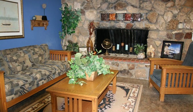 Interior common space with fireplace, comfortable seating, and decorative elements