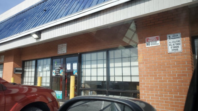 Exterior entrance with New Season Treatment Center signage visible on glass doors and brick building facade