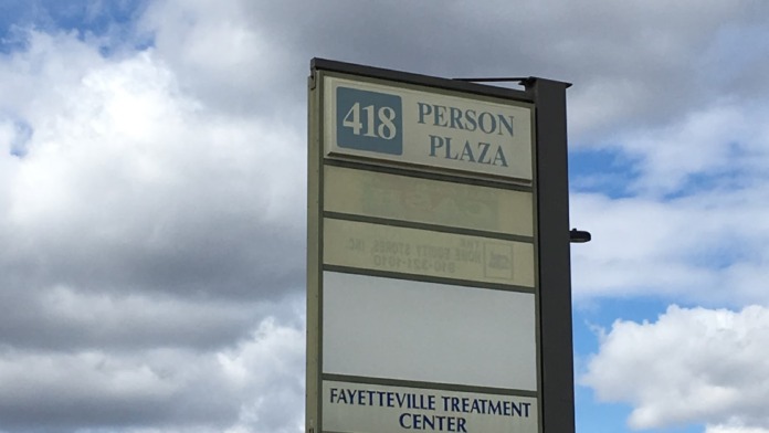 Outdoor sign displaying 418 Person Plaza and Fayetteville Treatment Center identification signage