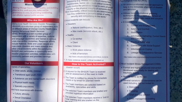 Interior display of educational posters covering crisis incident information, interventions, and agency mission statement from OC Health Care Agency