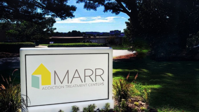 Exterior MARR Addiction Treatment Centers sign with landscaped grounds, mature trees, and facility buildings visible in background