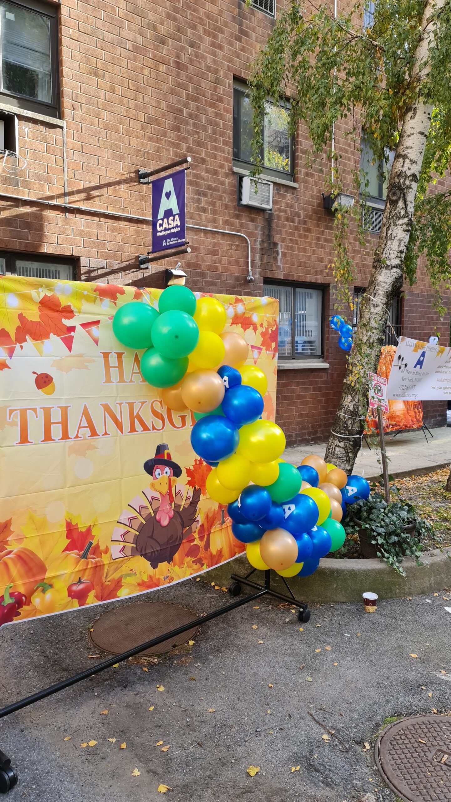 Exterior ground-level view showing facility entrance, signage, and seasonal balloon display decoration.