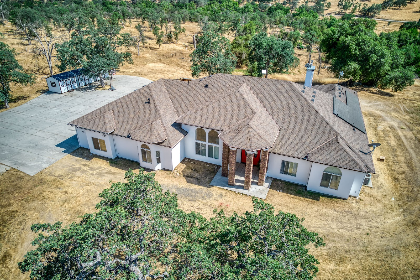 Exterior overhead view of treatment facility building with landscaping and surrounding terrain
